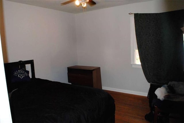 bedroom with ceiling fan and dark wood-type flooring