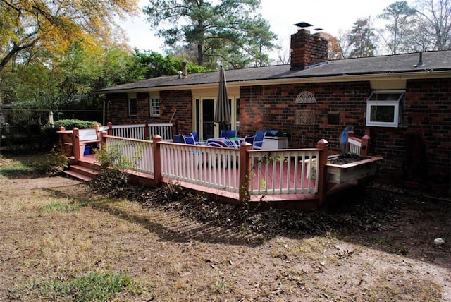 back of house with a deck