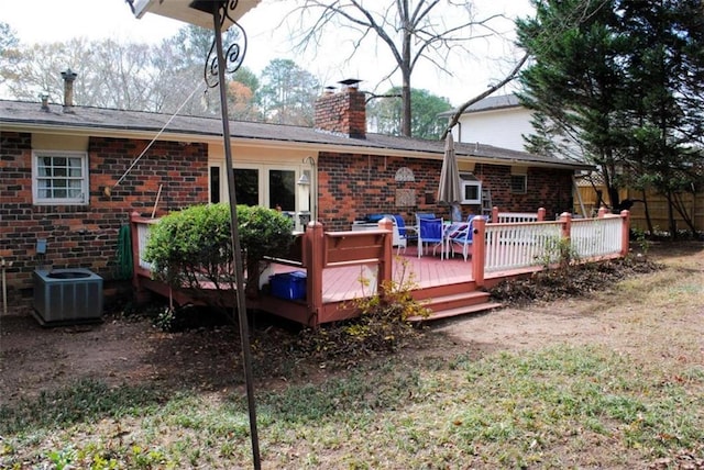 rear view of house featuring a wooden deck and central AC