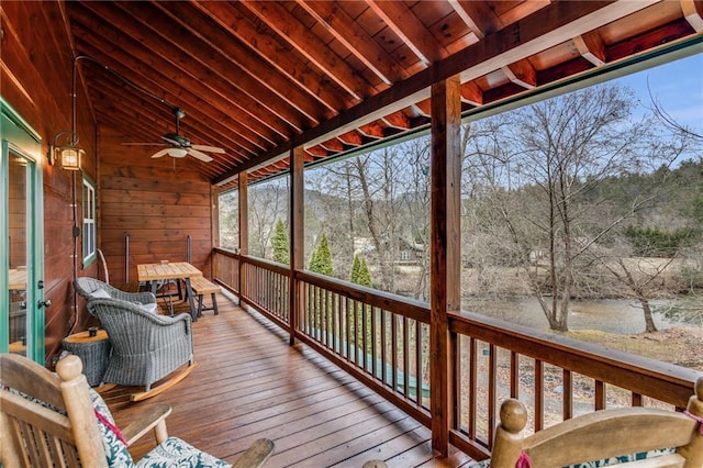 wooden deck featuring ceiling fan