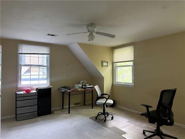 interior space with visible vents, ceiling fan, a wealth of natural light, and light colored carpet