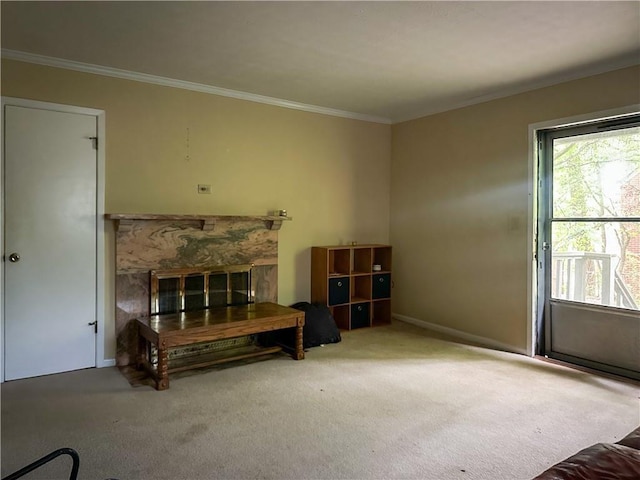 sitting room featuring crown molding, baseboards, carpet, and a fireplace