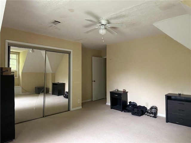 additional living space featuring baseboards, a ceiling fan, and carpet