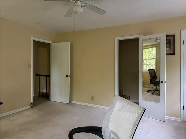 sitting room featuring carpet floors, a ceiling fan, and baseboards