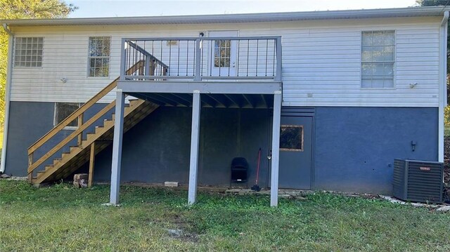 rear view of house featuring a yard, central air condition unit, and a deck