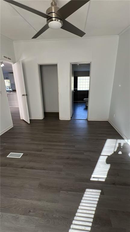 empty room with dark wood-type flooring and ceiling fan