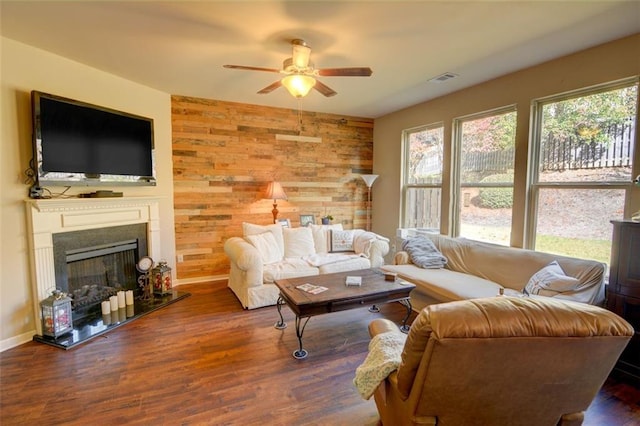 living room featuring wooden walls, dark hardwood / wood-style flooring, and ceiling fan