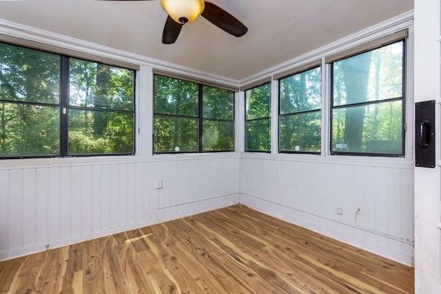 unfurnished sunroom with ceiling fan