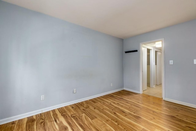 unfurnished room with light wood-type flooring