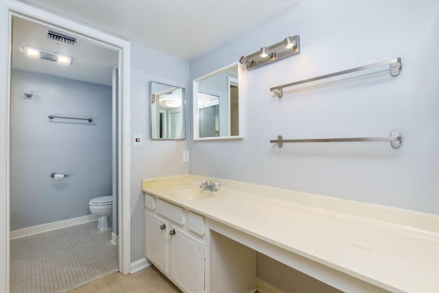 bathroom with tile patterned floors, vanity, and toilet