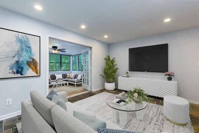 living room featuring dark hardwood / wood-style flooring and ceiling fan