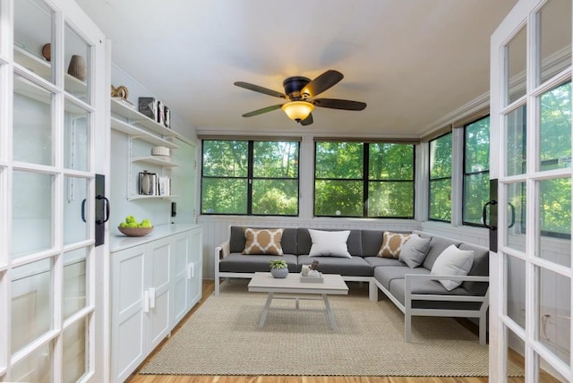 living room featuring ceiling fan and light hardwood / wood-style flooring