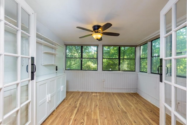 unfurnished sunroom featuring plenty of natural light and ceiling fan