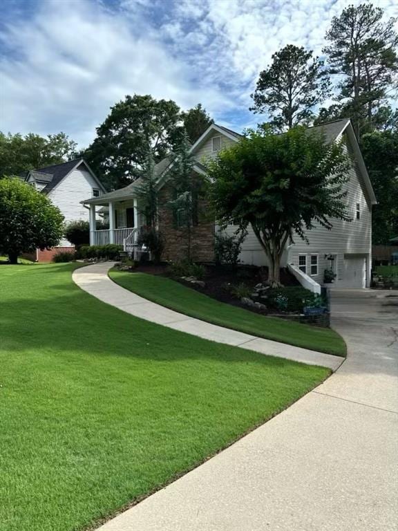 60 Stonehedge Dr, Buford, GA 30518 - obstructed view of property with a front lawn, concrete driveway, and a garage