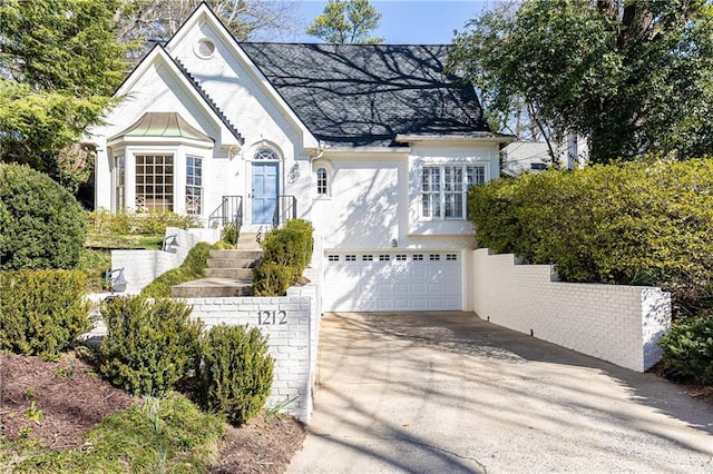 view of front of property with concrete driveway, brick siding, and an attached garage