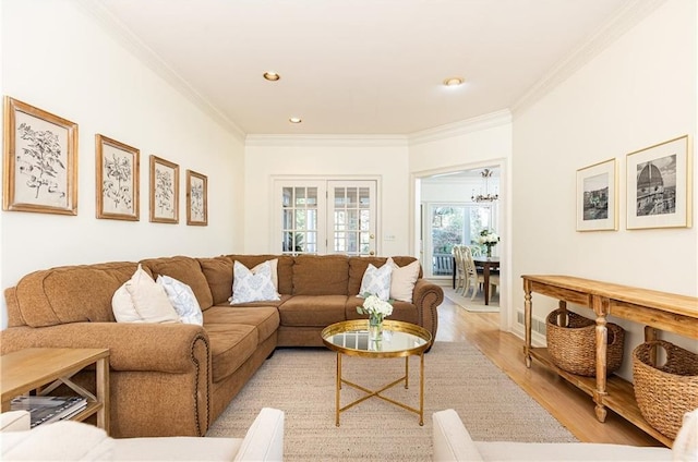 living area featuring recessed lighting, french doors, crown molding, and light wood-style flooring