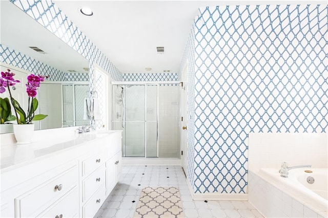 bathroom featuring a bath, a stall shower, vanity, and visible vents