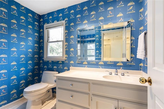 bathroom with toilet, tile patterned flooring, vanity, and wallpapered walls