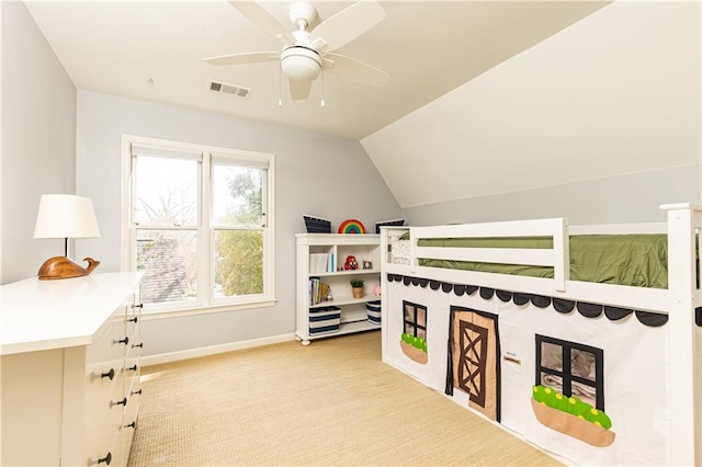 bedroom featuring baseboards, visible vents, a ceiling fan, vaulted ceiling, and carpet flooring