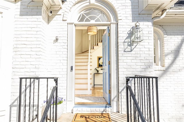 property entrance featuring brick siding