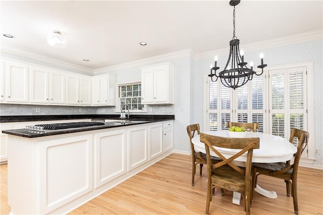 kitchen with crown molding, stainless steel gas cooktop, light wood-style flooring, and wallpapered walls