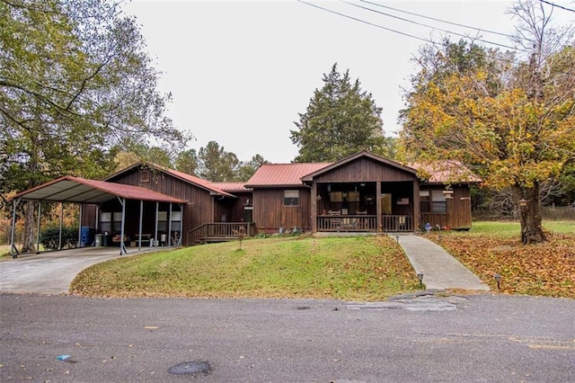 bungalow-style home with a carport, covered porch, and a front lawn