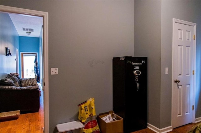 hallway with hardwood / wood-style floors