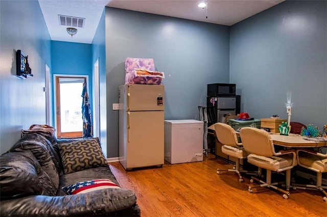 home office with light hardwood / wood-style floors