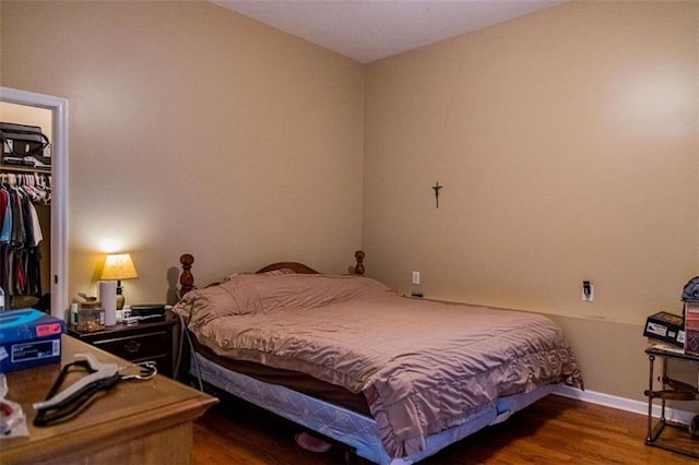 bedroom with wood-type flooring and a closet