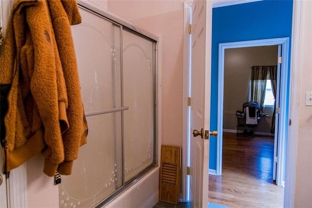 bathroom featuring combined bath / shower with glass door and hardwood / wood-style flooring