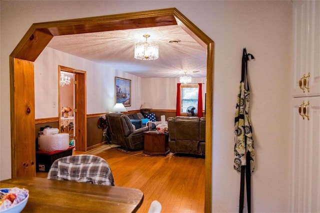 living room featuring light hardwood / wood-style floors and an inviting chandelier