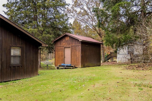 view of outbuilding featuring a lawn