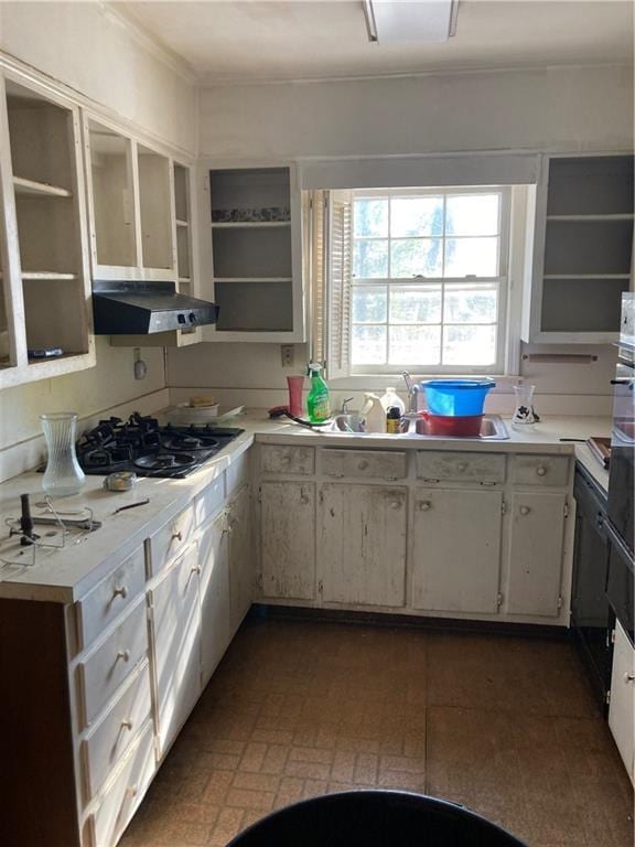 kitchen featuring sink, white cabinetry, and black gas stovetop