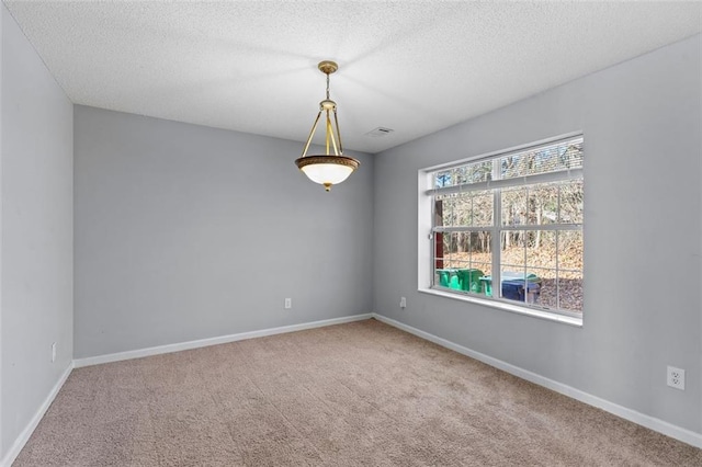 carpeted spare room featuring a textured ceiling