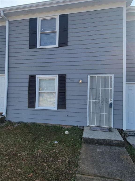 doorway to property with a yard