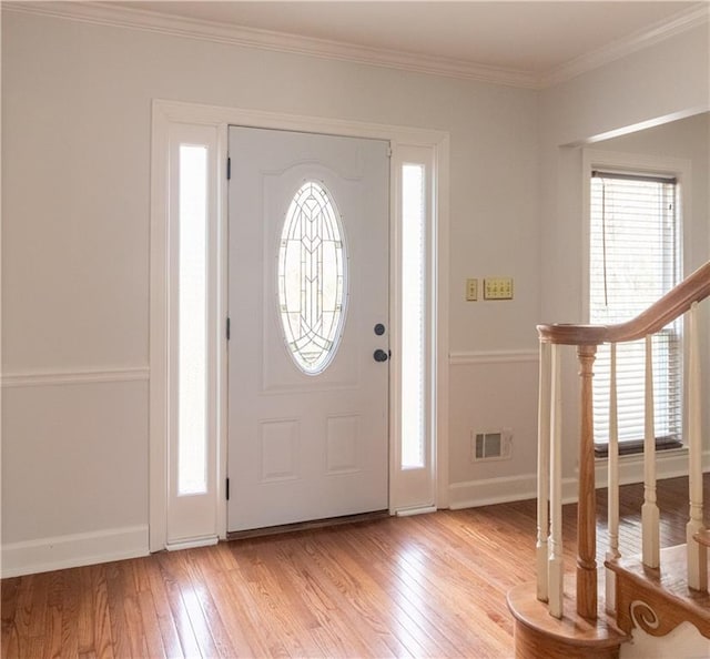 5150 Rockford Ln, Stockbridge, GA 30281 - entrance foyer with baseboards, crown molding, stairs, visible vents, and light wood finished floors