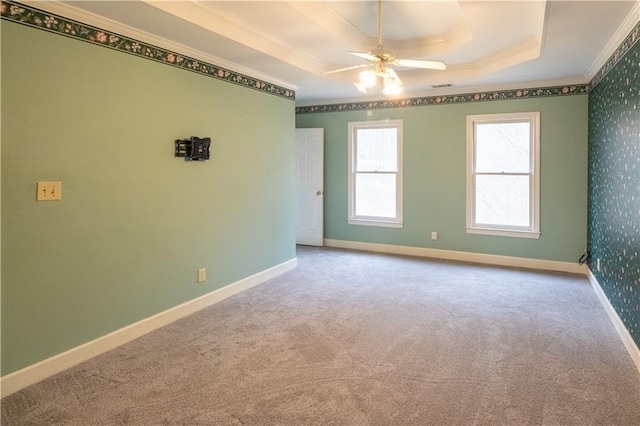 5150 Rockford Ln, Stockbridge, GA 30281 - carpeted spare room featuring baseboards, a raised ceiling, crown molding, visible vents, and ceiling fan