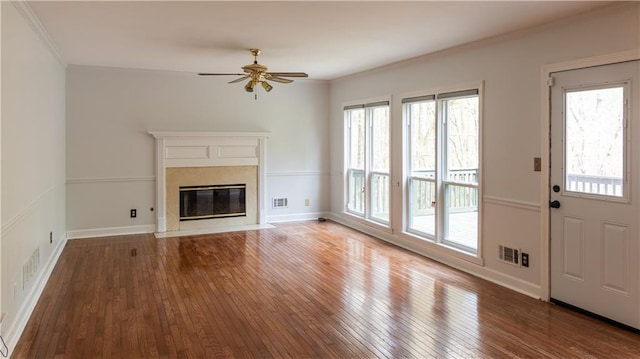 5150 Rockford Ln, Stockbridge, GA 30281 - unfurnished living room featuring a fireplace, a ceiling fan, ornamental molding, visible vents, and wood-type flooring