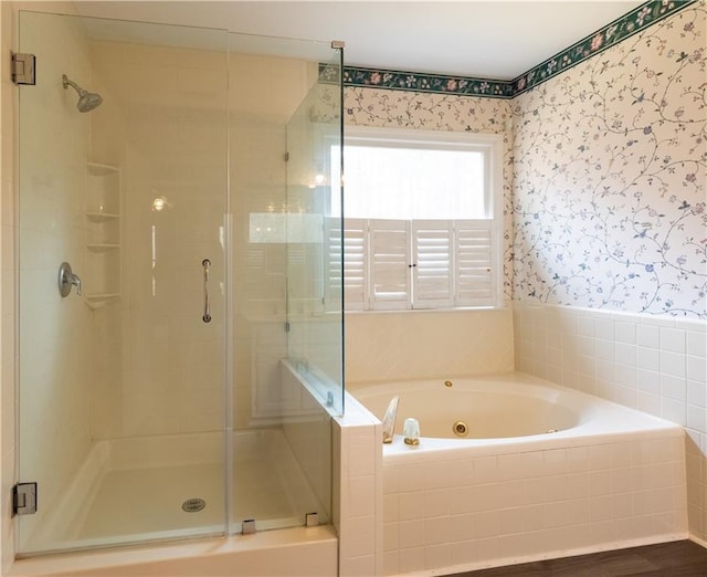 5150 Rockford Ln, Stockbridge, GA 30281 - bathroom with a jetted tub, a stall shower, wood finished floors, and wallpapered walls