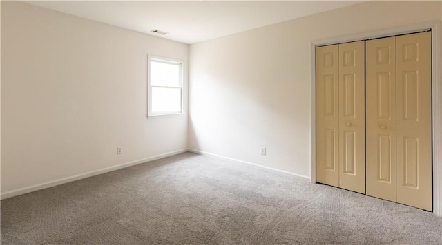5150 Rockford Ln, Stockbridge, GA 30281 - unfurnished bedroom with a closet, carpet, visible vents, and baseboards