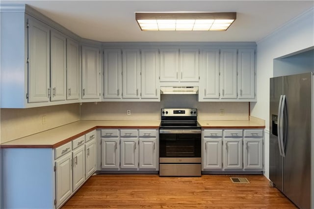 5150 Rockford Ln, Stockbridge, GA 30281 - kitchen featuring light countertops, light wood-style floors, under cabinet range hood, gray cabinetry, and stainless steel appliances