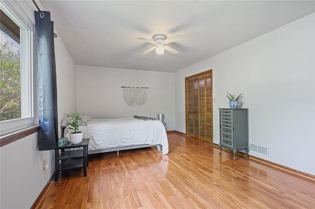 3916 S Martin Way, Lithia Springs, GA 30122 - bedroom with baseboards, multiple windows, wood finished floors, and visible vents