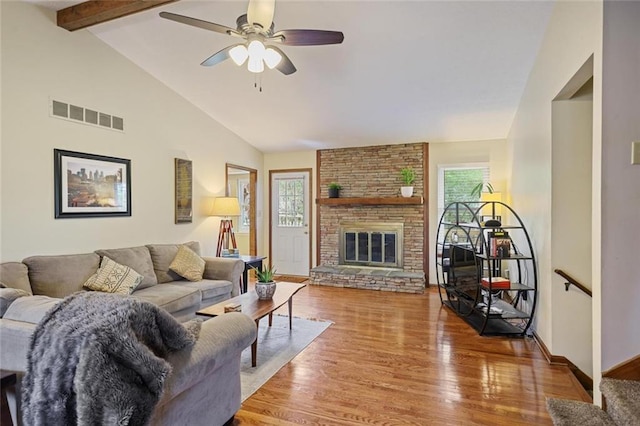 3916 S Martin Way, Lithia Springs, GA 30122 - living room with visible vents, a brick fireplace, wood finished floors, beam ceiling, and ceiling fan