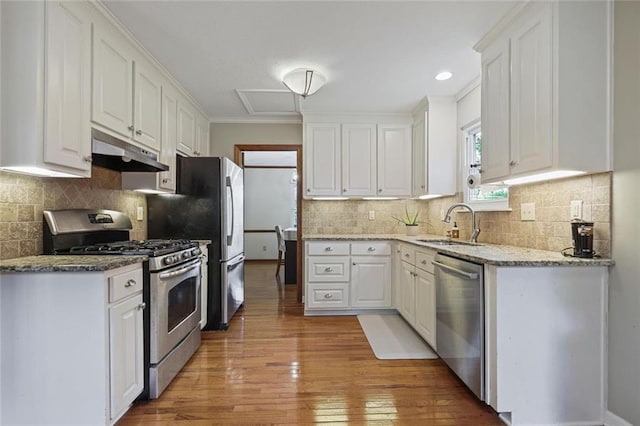 3916 S Martin Way, Lithia Springs, GA 30122 - kitchen featuring a sink, light wood finished floors, stainless steel appliances, white cabinetry, and under cabinet range hood