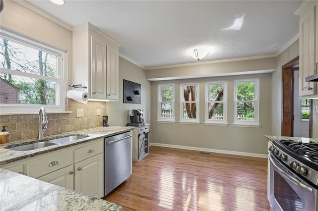 3916 S Martin Way, Lithia Springs, GA 30122 - kitchen with appliances with stainless steel finishes, decorative backsplash, a sink, and light wood finished floors