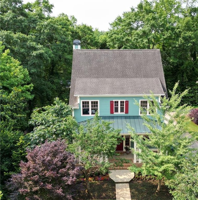 453 Carter Ave SE, Atlanta, GA 30317 - view of front of house featuring a chimney, a standing seam roof, roof with shingles, a porch, and a metal roof