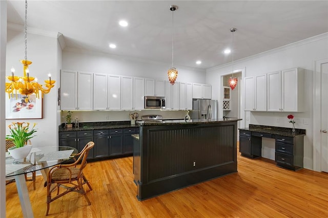 453 Carter Ave SE, Atlanta, GA 30317 - kitchen featuring stainless steel appliances, ornamental molding, a chandelier, white cabinetry, and hanging light fixtures