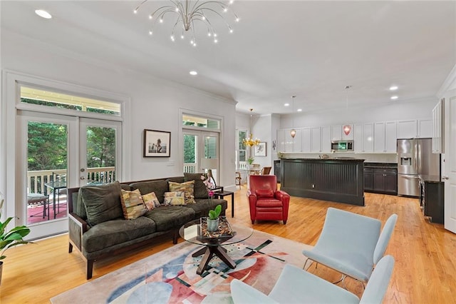 453 Carter Ave SE, Atlanta, GA 30317 - living area with a chandelier, light wood-type flooring, crown molding, recessed lighting, and french doors