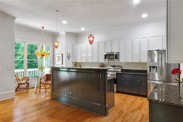 453 Carter Ave SE, Atlanta, GA 30317 - kitchen featuring appliances with stainless steel finishes, crown molding, recessed lighting, pendant lighting, and light wood-style floors