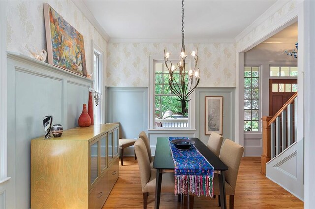 453 Carter Ave SE, Atlanta, GA 30317 - dining area featuring wallpapered walls, a chandelier, crown molding, plenty of natural light, and wainscoting